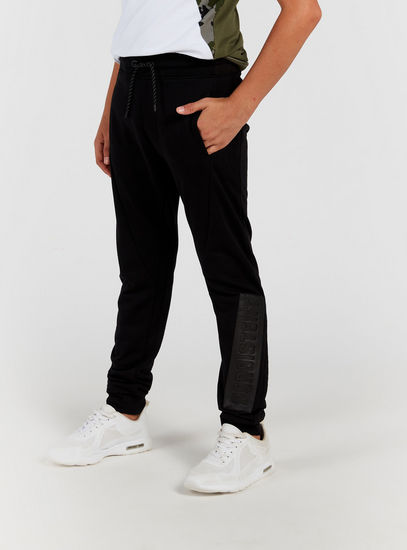 Embossed Mid-Rise Jog Pants with Drawstring Closure and Pockets