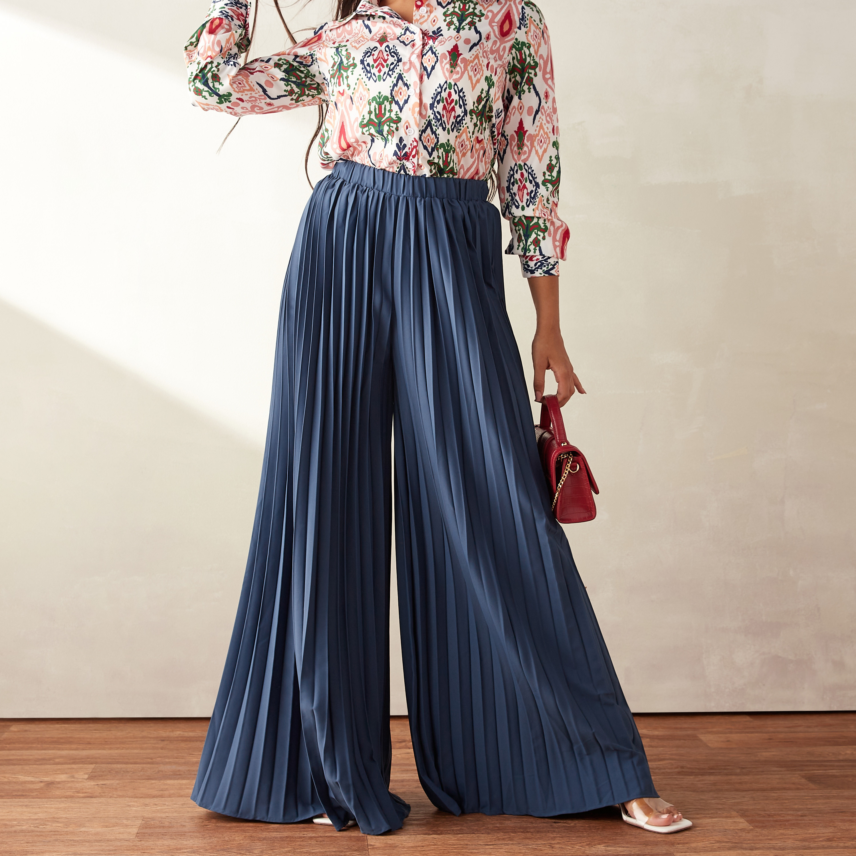Red pleated palazzo pants by Chique | The Secret Label